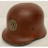A German WWII style lightweight fire helmet, red with VW factory hand painted decal.