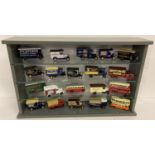 A wooden and glass display cabinet containing 25 "Days Gone" vintage advertising style model cars.