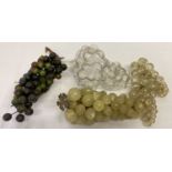 A vintage bunch of grapes made from onyx together with a bottle in the shape of a bunch of grapes.