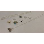 A collection of white metal and costume jewellery to include a vintage coach and coachmen pendant.