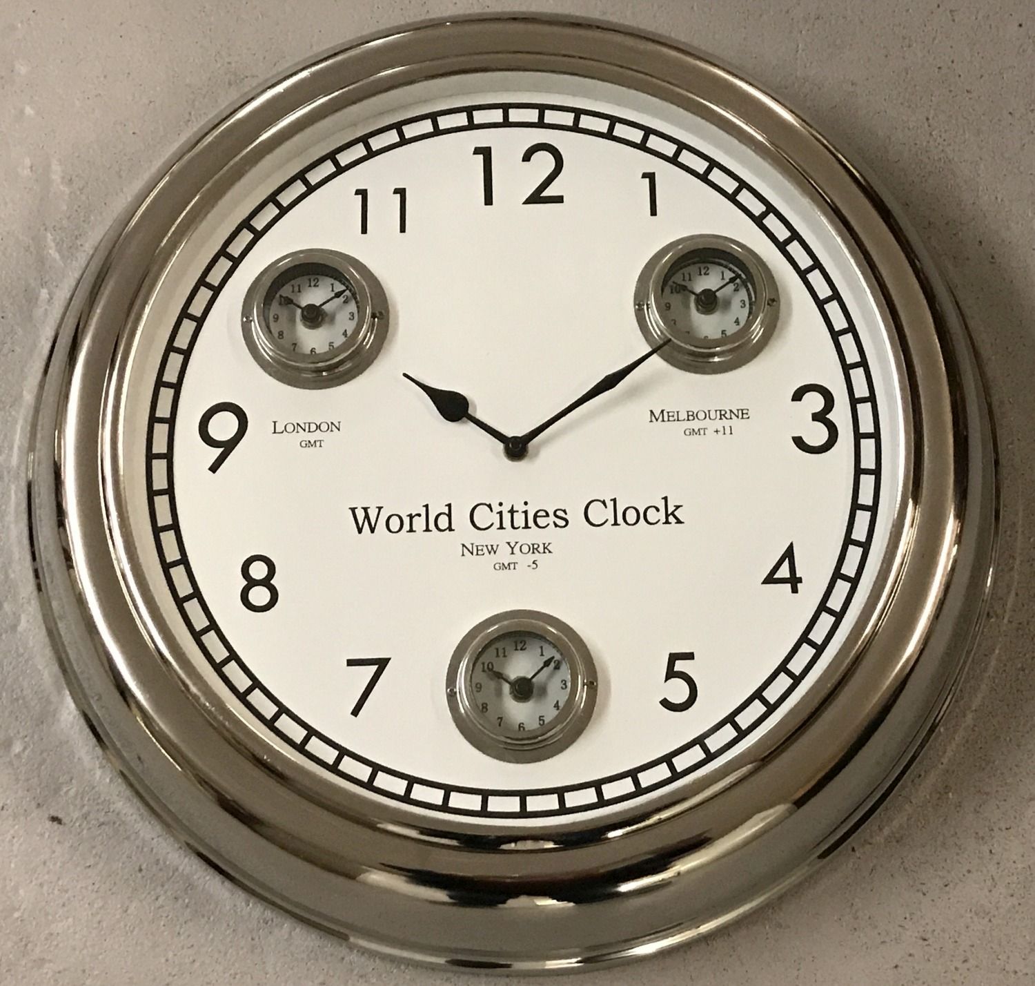 A large modern wall hanging, multi dial, world cities, clock with chrome finish.