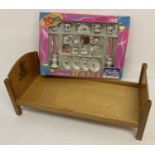 A vintage dolls bed with transfer detail to headboard.