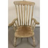 A vintage stripped pitch pine slat back arm chair.