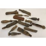 A collection of vintage wooden handled rug making tools and cutters.