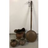A vintage wooden handled copper bed pan with bird decoration to front.