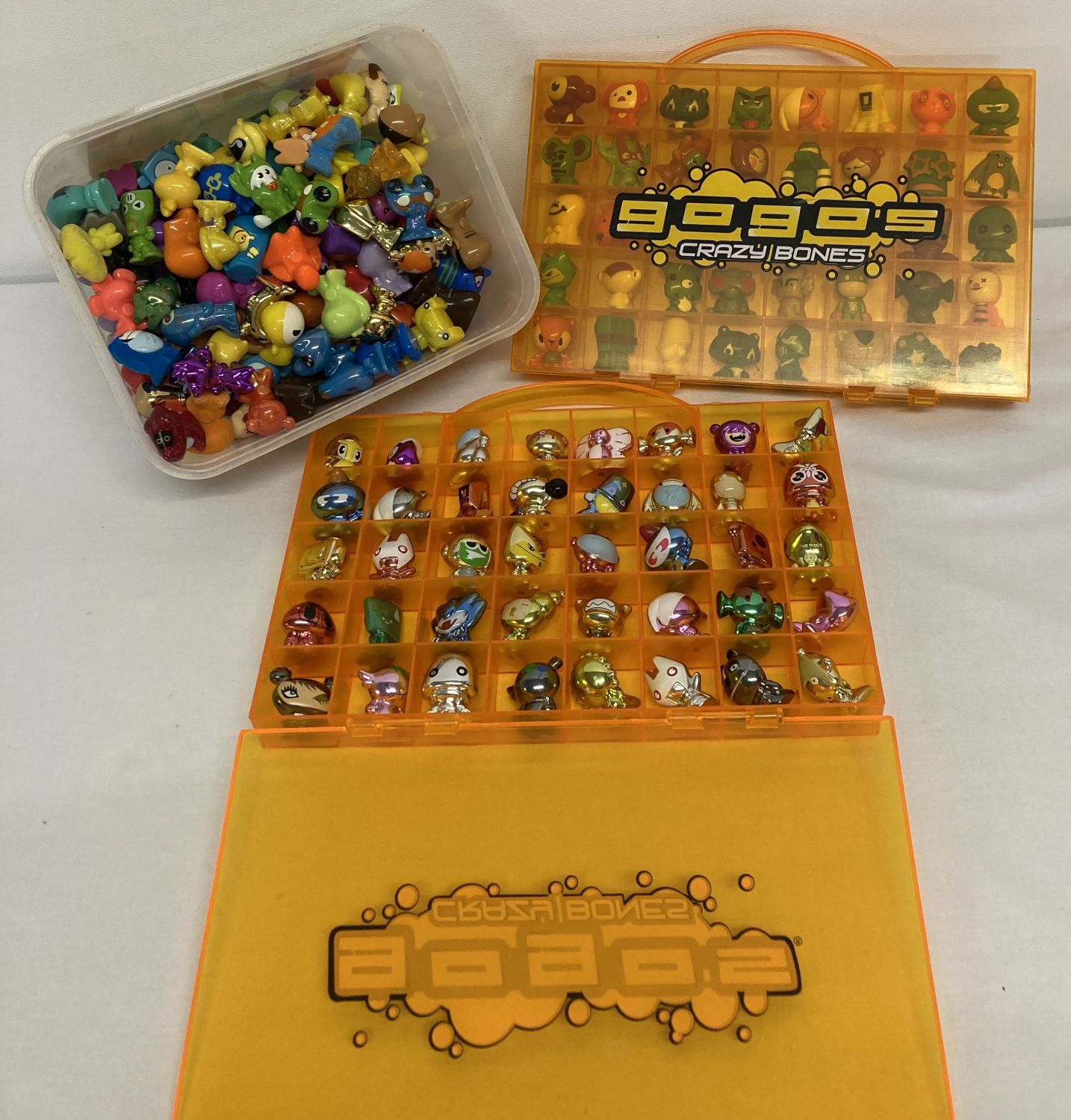 A collection of 220+ vintage Gogo's Crazy Bones figures and 2 carry cases.