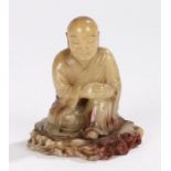 Chinese soapstone carved figure, Qing dynasty, 19th Century, of a seated figure on a base, 8cm high