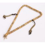 Tibetan necklace, with beads and two metal drops with amulets to the end, 56cm long Minor knocks and