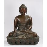 Seated Buddha, bronzed effect metal, with a hand placed upon the lap and one rested on the knee