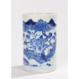 Chinese blue and white porcelain brush pot, decorated with a mountainous scene behind a village,