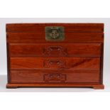 Chinese collectors cabinet, the hinged top above three long drawers flaked by brass handles and