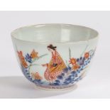 Japanese porcelain tea bowl, Edo period, with a figure in a garden, decorated in blues, red and