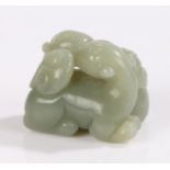 Chinese carved jade, of two mythical beasts between a scroll, 44mm longOverall good order