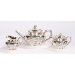 Chinese three piece silver tea service, maker Wang Hing, with dragons curling around the bodies of