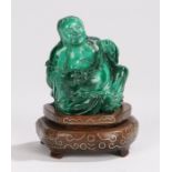 Chinese malachite carved Buddha, seated position on a wire work inlaid hardwood stand, 9.5cm high