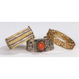 Chinese/Tibetan bangles, three examples, the first with a cabochon stone and bead surround, the