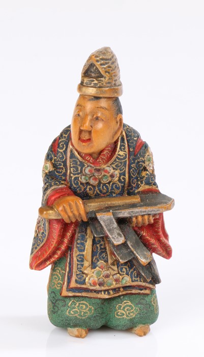 Japanese polychrome caved boxwood netsuke, by Nakamura Shuzan, of a man in court robes, signed to