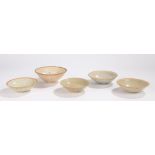 Chinese celadon bowls, to include three with glazed interiors and glaze free top edge, together with