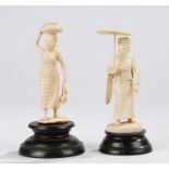 Two Japanese ivory Okimonos, early 20th Century, as a lady holding an umbrella and the other with