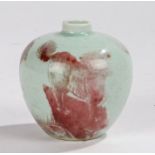 Chinese underglaze copper red vase painted with three Shishi on rocky outcrops, bearing Kangxi six