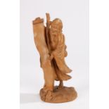 Japanese Meiji period boxwood carved okimono, of a standing scholar holding a long scroll, a toad to