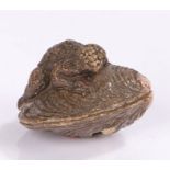 Japanese pottery netsuke, with Kappa on a clam, signed to the base Teiji, 3.6cm longChip to the