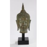 Early 20th Century Thai Buddha head in bronze, on a stand, 45cm high