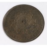 Japanese Edo period bronze mirror, decorated with winged beasts and a flower to the centre, 23cm