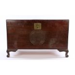 Chinese camphor wood chest, with a carved medallion to the top and front above claw and ball feet,