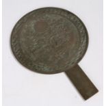 Japanese Edo period bronze hand held mirror, decorated with a turtle below flowers and a sun,