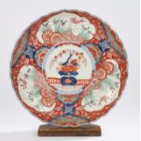 Japanese Meiji period porcelain charger, with flowers to the centre and koi carps to the panels