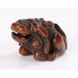 Japanese Edo period boxwood netsuke, signed Sessai, of a shishi with a ball in his mouth, signed