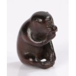 Japanese carved wood netsuke, signed Hakuryu, of a seated monkey eating an apple, signed to the