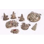 Collection of Chinese white metal amulets, four with figures, two foo dog heads, a dog of foo and