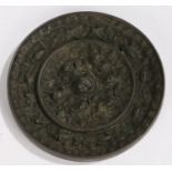 Japanese Edo period bronze mirror, decorated with beasts, dogs, birds and grapes, 15cm diameter