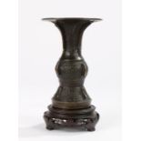 Chinese bronze vase, with a flared lip above and foliate and geometric decorated body, 14cm high,