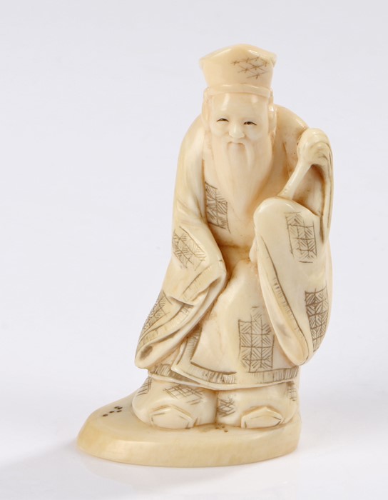 Japanese Meiji period ivory okimono, carved as a standing figure with a long beard, 9.5cm
