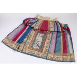 Chinese silk skirt, the front and rear panels embroidered with depictions of figures in a landscape,