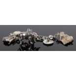 Spanish silver charm bracelet, with a bull and bull fighter a hat and cloak, together with a