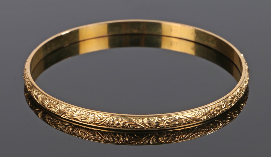 Yellow metal bangle, with flower head design, MZ under an eagle mark to the interior, 70mm diameter