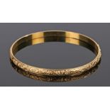 Yellow metal bangle, with flower head design, MZ under an eagle mark to the interior, 70mm diameter