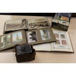Two postcard and snapshot albums, cigarette card album, loose cigarette cards, box brownie camera (