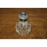 Edwardian white metal mounted perfume atomiser, with engine turned cap and clear glass lower