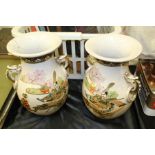 Pair of Japanese satsuma twin handled vases, the crackle glazed exterior decorated with figures in a