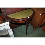 Mahogany demi-lune occasional table, with tooled green leatherette inset top, on three reeded