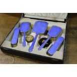 Blue enamel decorated dressing table set, consisting of hand mirror, two hair brushes and two