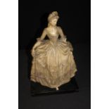 Bisque figure depicting a lady in a flowing gown, on a plinth base, 46.5cm high