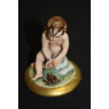 Capo-Di-Monte Porcelain figure, of a seated nude by a fire
