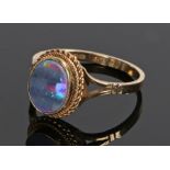 9 carat gold and opal ring, the head above divided shoulders and with rope weaved effect under the