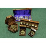 Brass sextant, map magnifier, compass and set of six tot cups, all housed in teak cases with brass